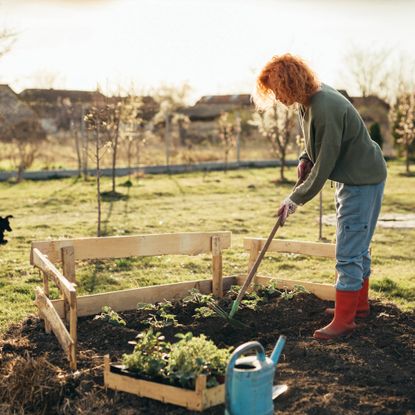 Woman working the soil in garden