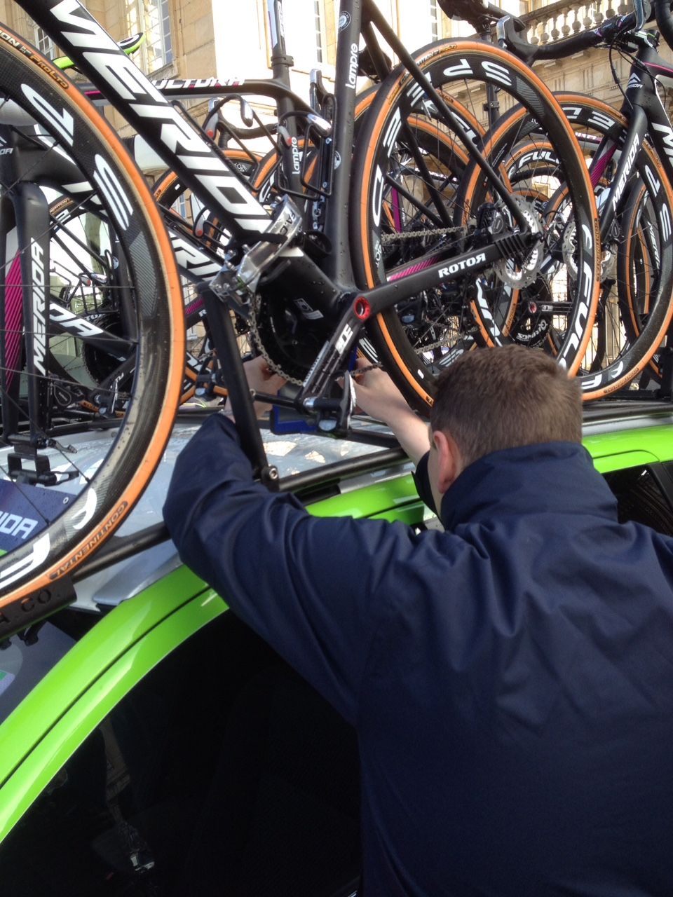 The officials checked spare bikes on the roof of the team car