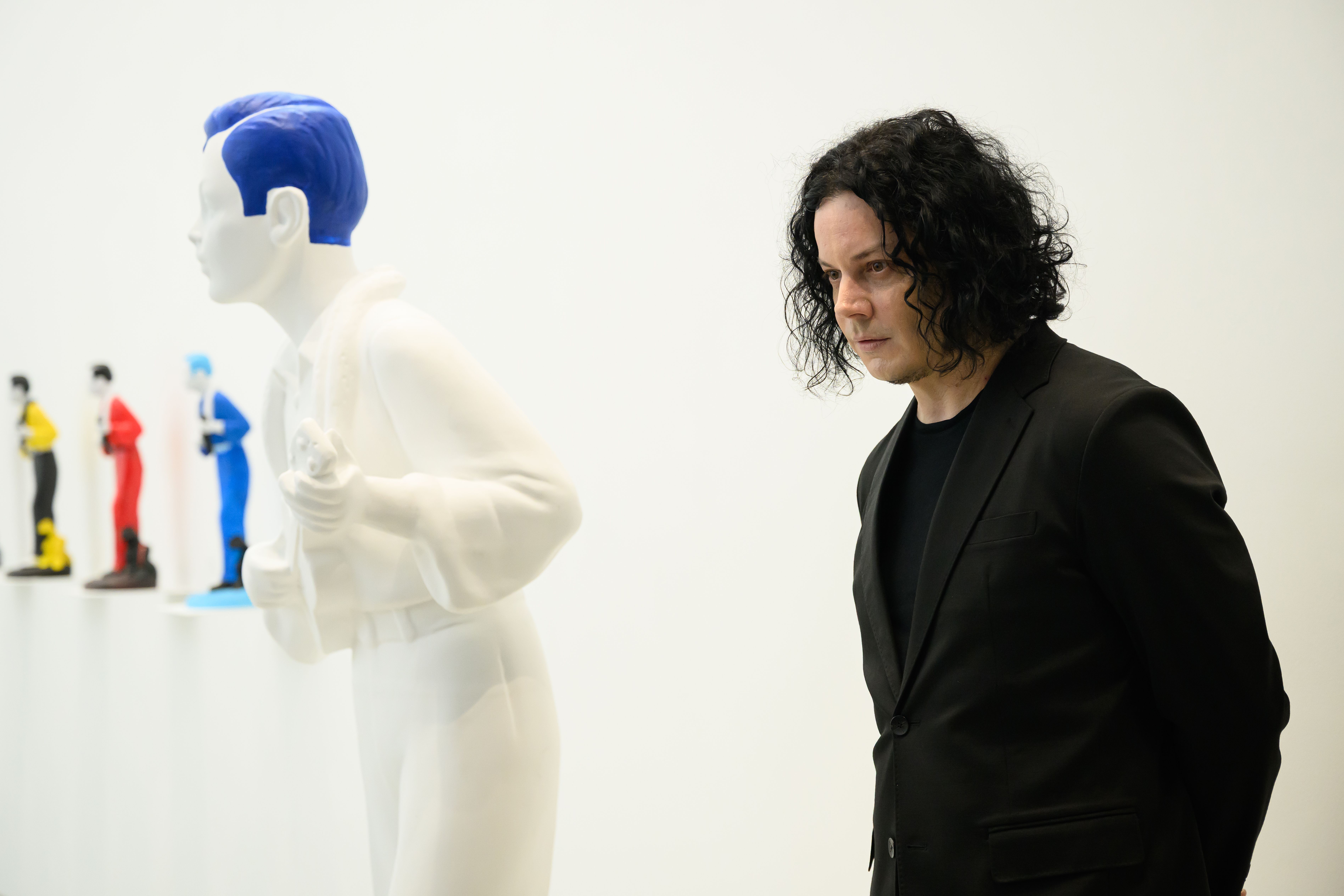 LONDON, ENGLAND - MAY 28: US musician and artist Jack White stands with "Ukelele Joe Blue Haired Model" (2026) as he attends a photocall for the "Jack White: These Thoughts May Disappear" exhibition at Newport Street Gallery on May 28, 2026 in London, England. The exhibition marks the first public presentation of works by the American artist and musician Jack White, featuring his monumental sculpture The Red Tree (2015). (Photo by Leon Neal/Getty Images)
