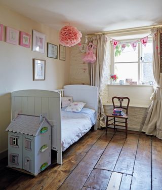 Kid’s bedroom with bed and chair and wood floor