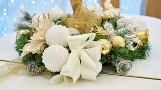 picture of a christmas wreath with large bow on it