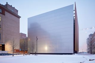 large, metal faced building in the snow