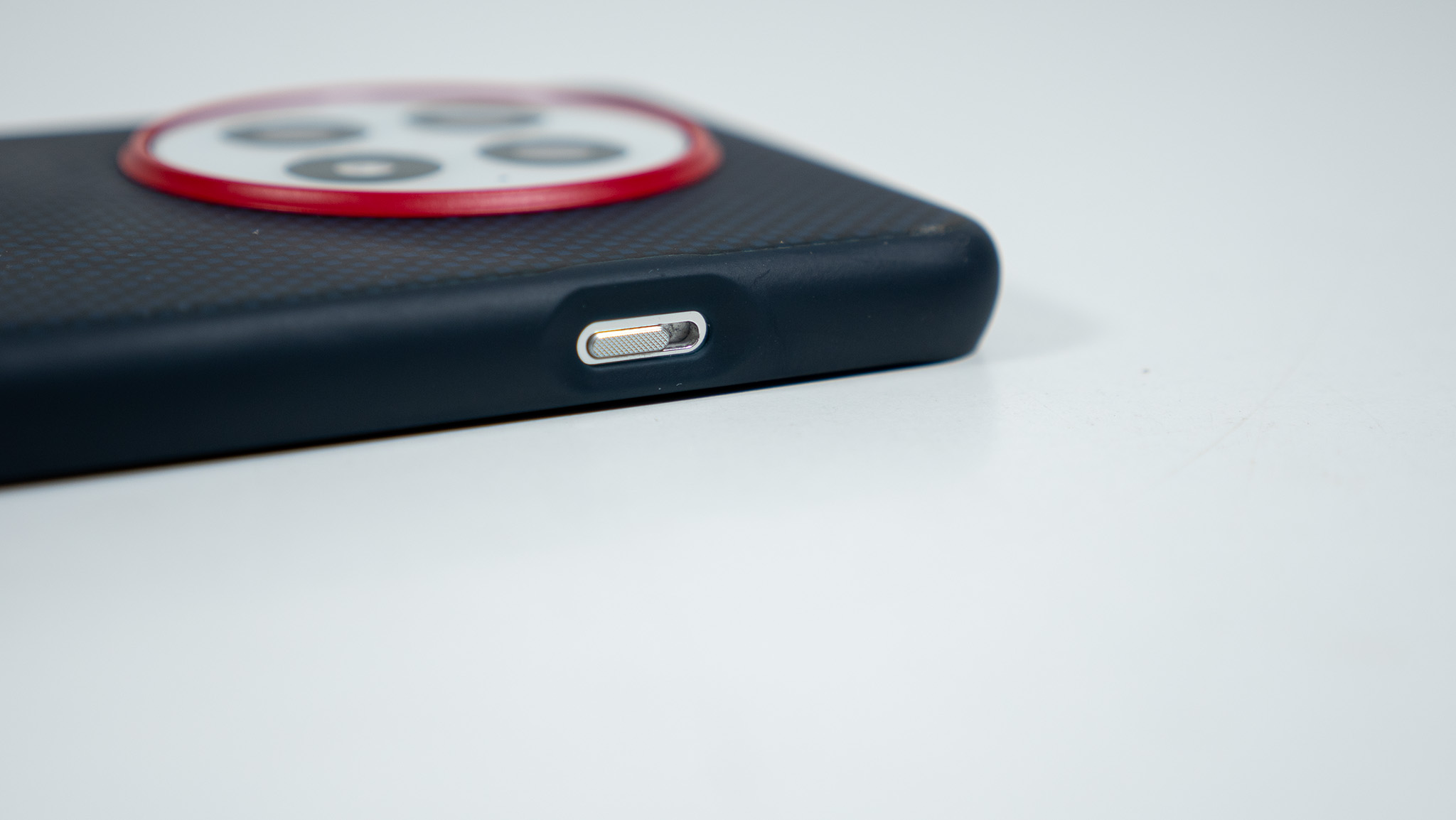 The alert slider opening on the official blue OnePlus 13 soft case