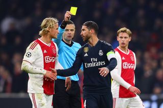Real Madrid defender Sergio Ramos is shown a yellow card in the Champions League against Ajax in 2019.