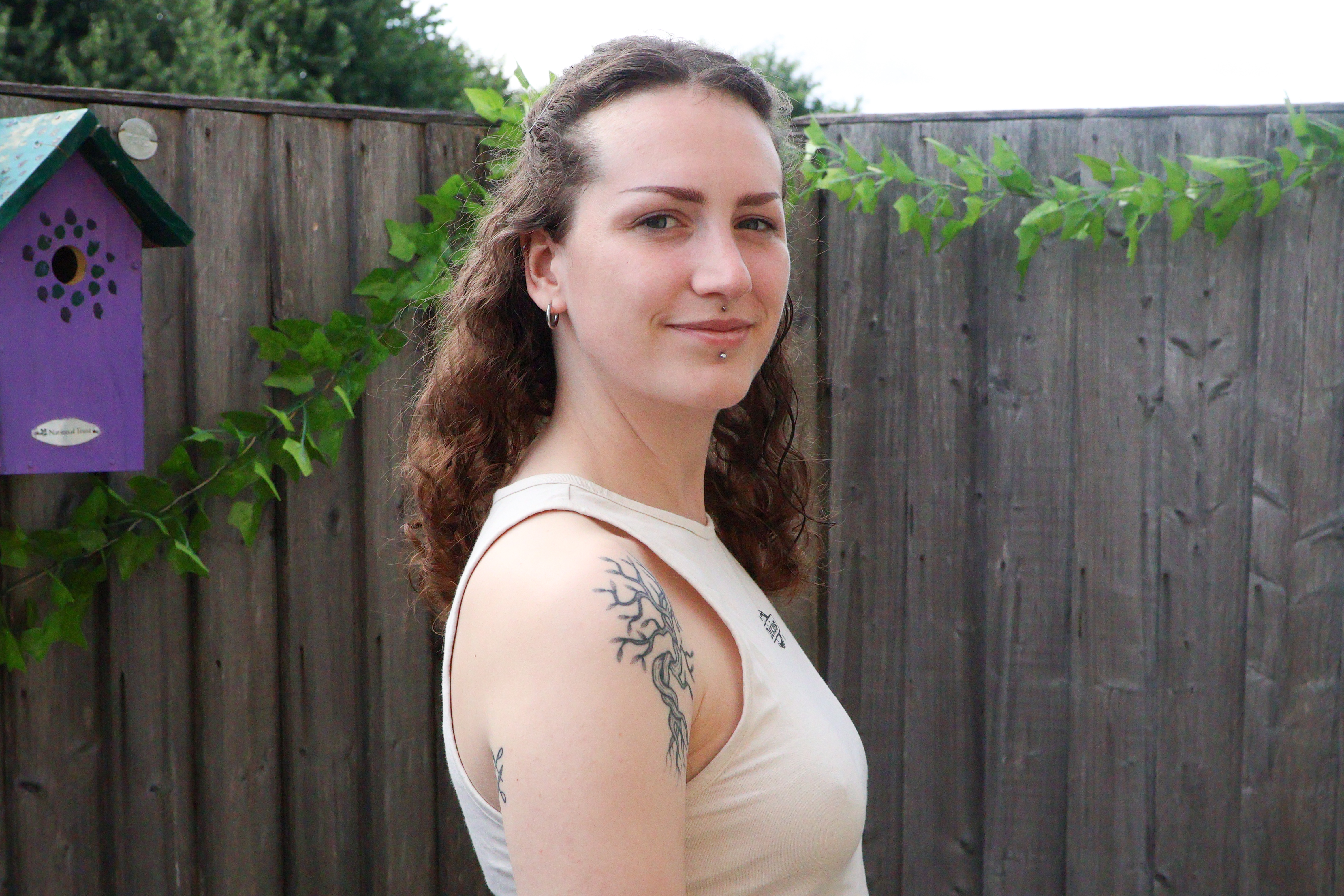A photo of a woman smiling taken on a Canon EOS R50 V mirrorless video camera