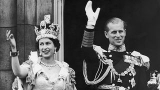 Queen Elizabeth II and the Duke of Edinburgh wave at the crowds from the balcony at Buckingham Palace