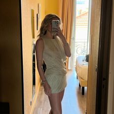 Eliza Huber wearing a Tory Burch draped minidress in a mirror selfie.