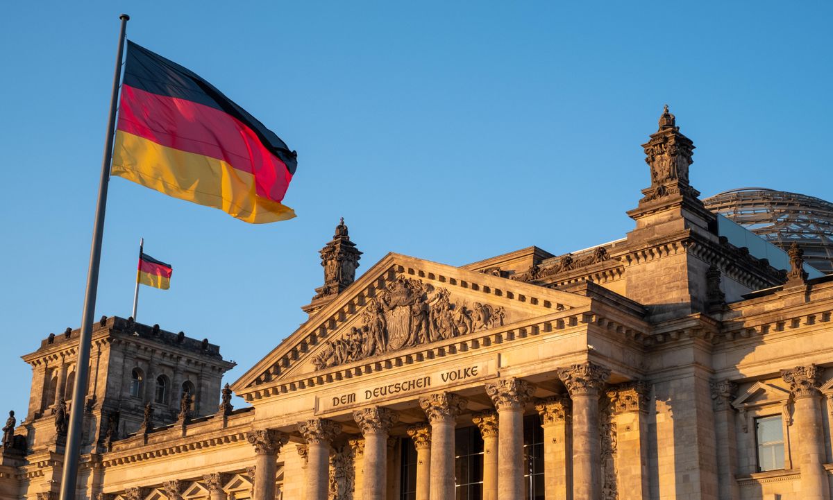 Bundestag building, Parliament of the Federal Republic of Germany, with German flag flying outside. Photographed in late afternoon during the heatwave of June 2019.