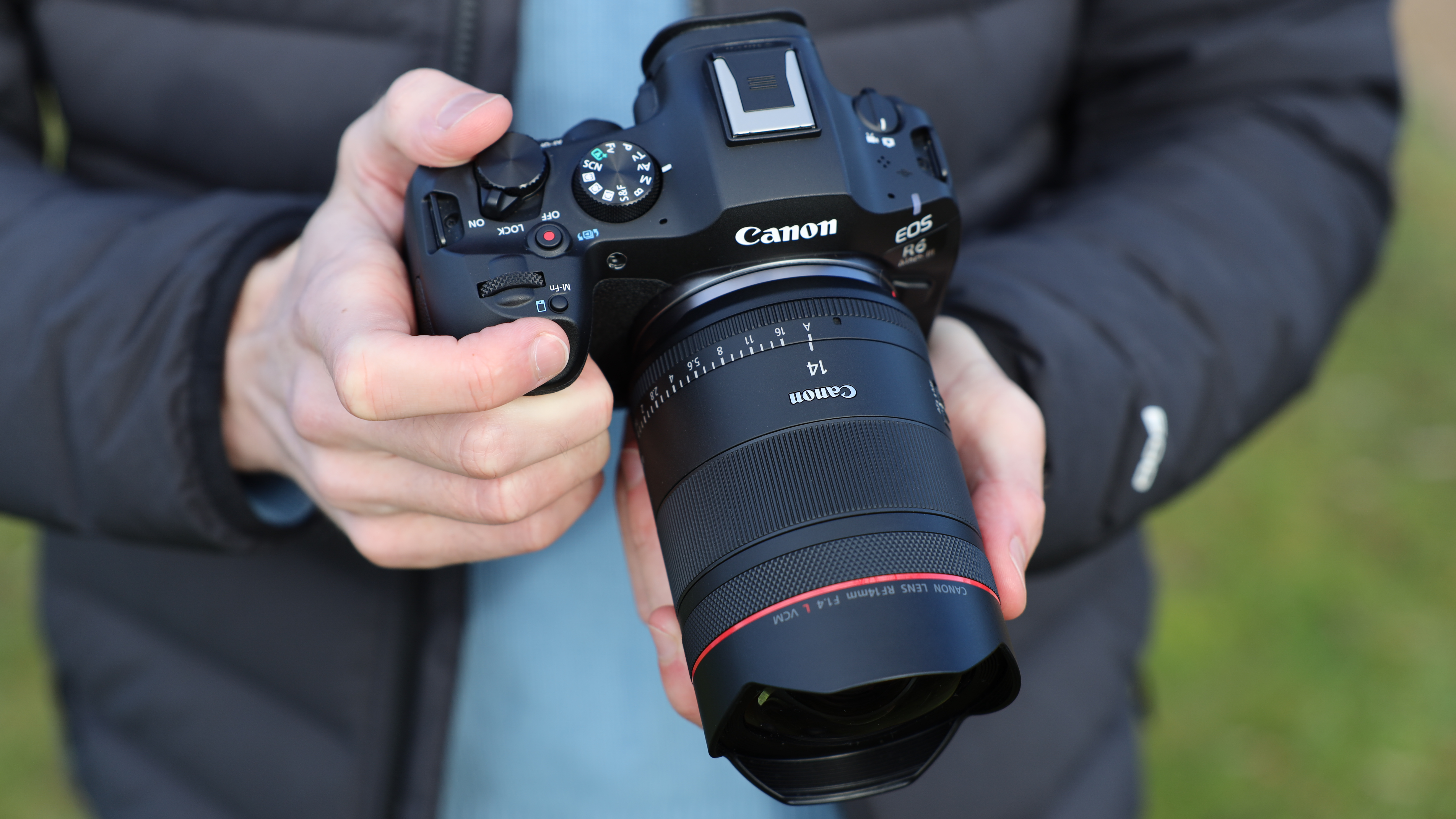 Canon EOS R6 Mark III camera with Canon RF 14mm f/1.4L VCM lens attached held in a pair of hands