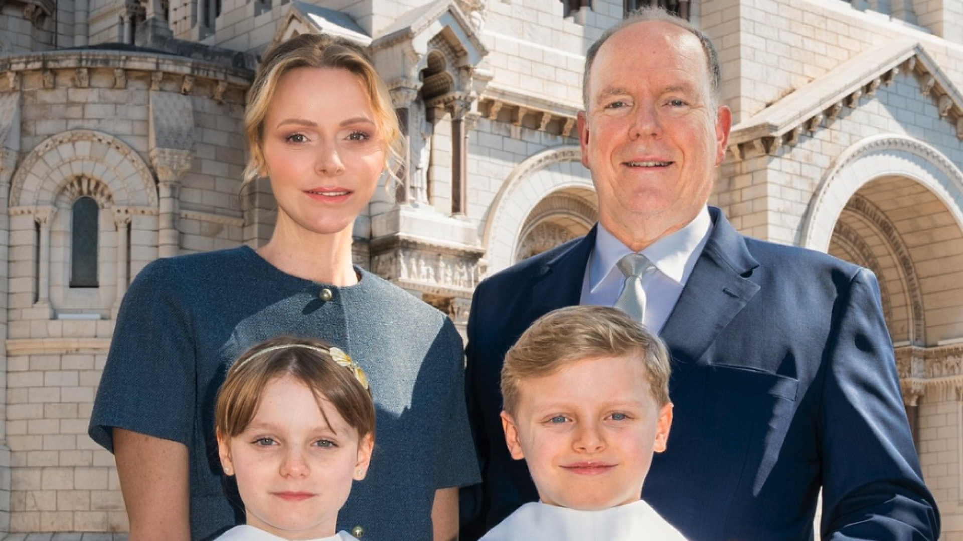 Princess Charlene and Prince Albert of Monaco pose with their twins, Jacques and Gabriella, who are wearing matching white gowns to take their First Communion