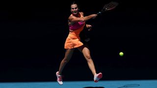 Aryna Sabalenka hits a forehand in midair during the Australian Open 2026