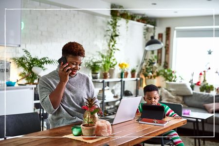 Mother looking after son and working from home