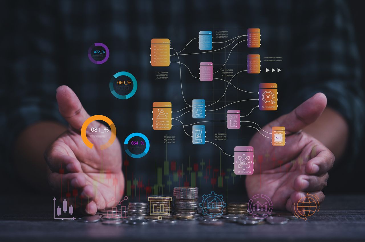 Hands guiding computer image of stocks