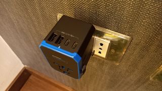Ceptics 70W World Travel Plug Adapter plugged into socket