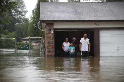 People wait to be rescued from their flooded homes after the area was flooded by Tropical Storm Harvey in Houston, Texas.