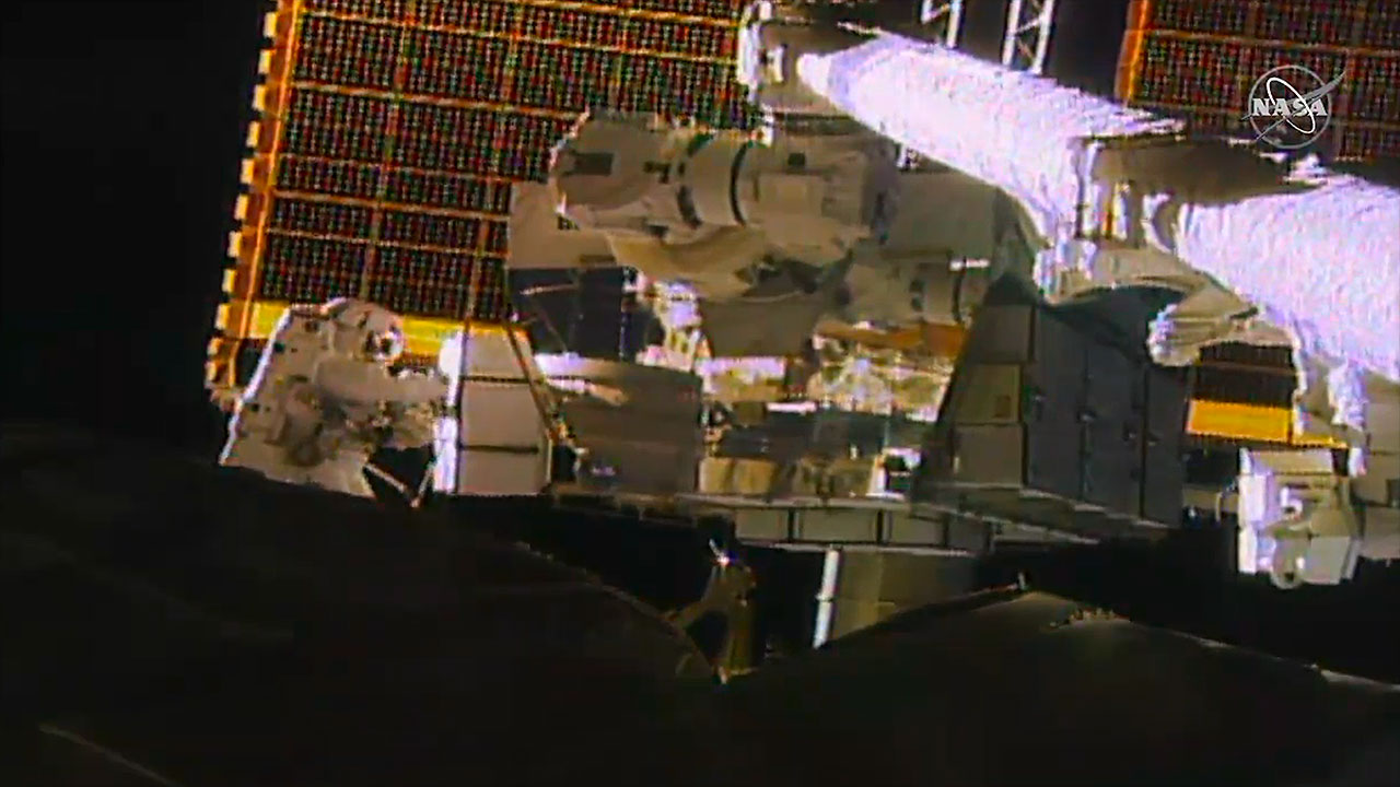 NASA astronaut Jessica Meir (left) holds a replacement lithium-ion battery to be installed on the International Space Station's port-side truss during her and Christina Koch's spacewalk on Wednesday (Jan. 15, 2020).