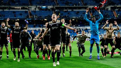 Ajax players celebrate their stunning win against Real Madrid at the Bernabeu