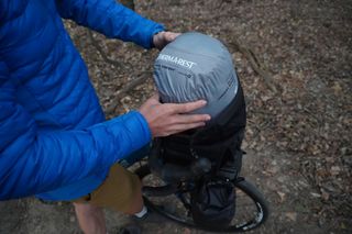 Image shows Stefan packing the Therm-a-Rest Space Cowboy sleeping bag into the Ortlieb Vario PS pannier backpack.