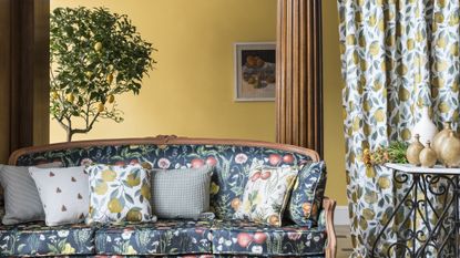 Fruit motif printed sofa and curtains in a country home