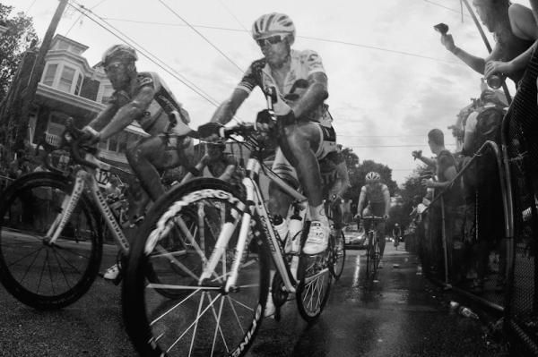 Riders get a soaking as they ride through a shower along the steep climb of the wall.