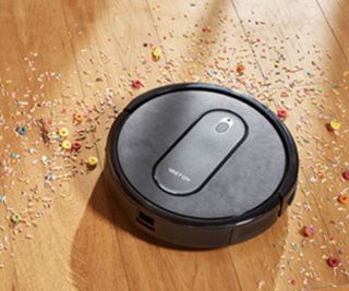 VacTidy Nimble T7 cleaning up cereal on a hardwood floor.
