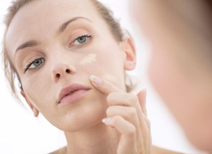 woman applying concealer