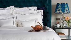 How to wash a silk pillowcase – silk pillowcases against upholstered headboard in blue