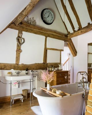 cottage bathroom with roll-top and beams