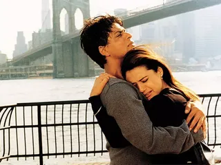 a man and woman cry while hugging standing outside of the brooklyn bridge in the movie kal ho naa ho