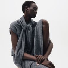 Model wearing a grey chasmere three piece knit set sold at Mytheresa