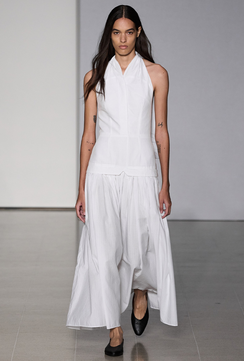 halter dress trend on Tove's  spring 2024 runway with a model wearing a white maxi styled with black pointed flats
