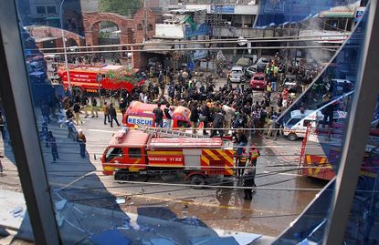 Security officials on the scene after a suicide bombing in Lahore