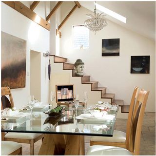 dining table with glass table and chandelier