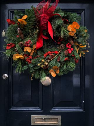 Christmas wreath on a black wooden door