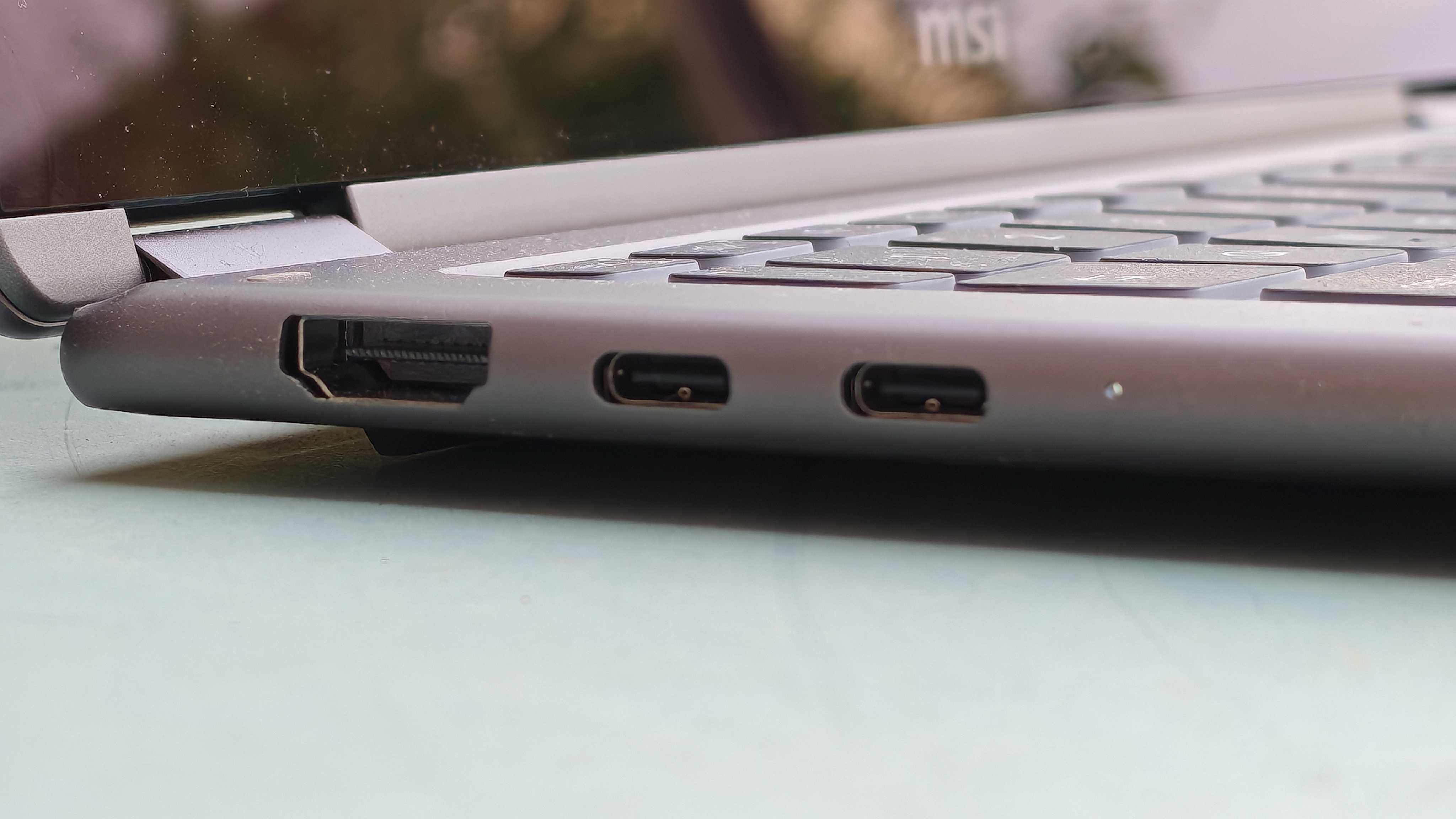 A silver MSI Prestige 14 Flip AI+ laptop on a garden table