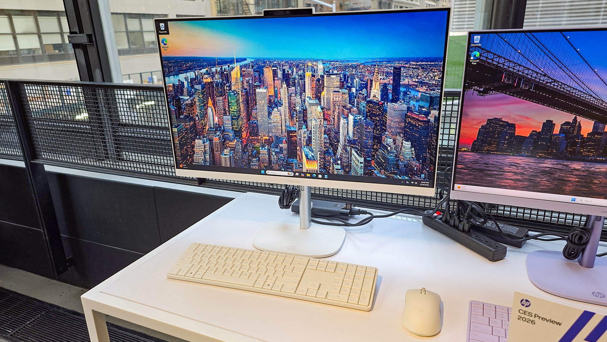 A side view of the HP OmniStudio X 27-inch All-in-One Desktop on a desk.