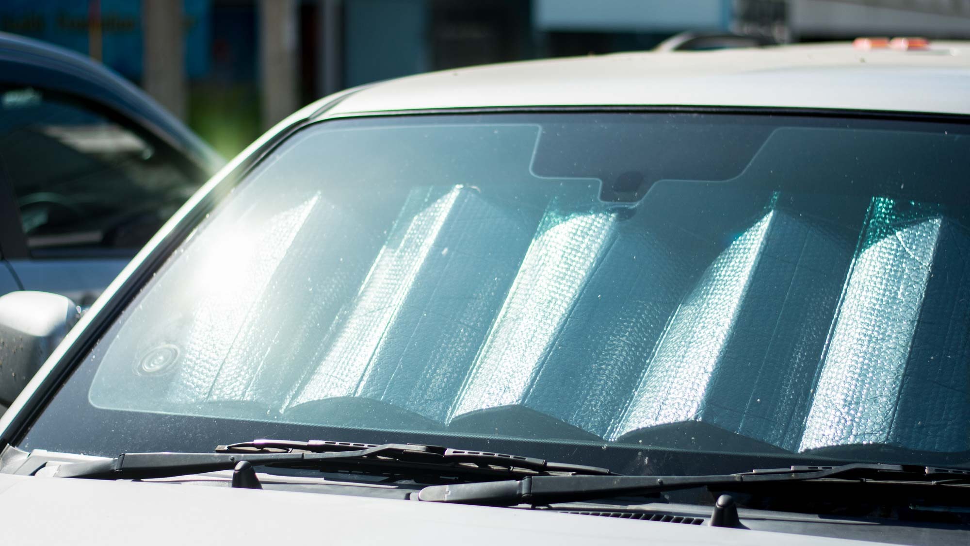 reflective windshield cover in silver car