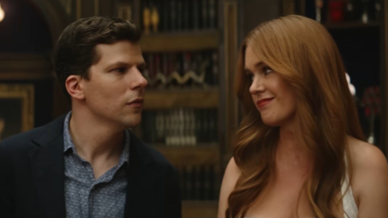 From left to right: Jesse Eisenberg looking at Isla Fisher.