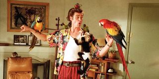 Jim Carrey as Ace Ventura with birds and a monkey on his body