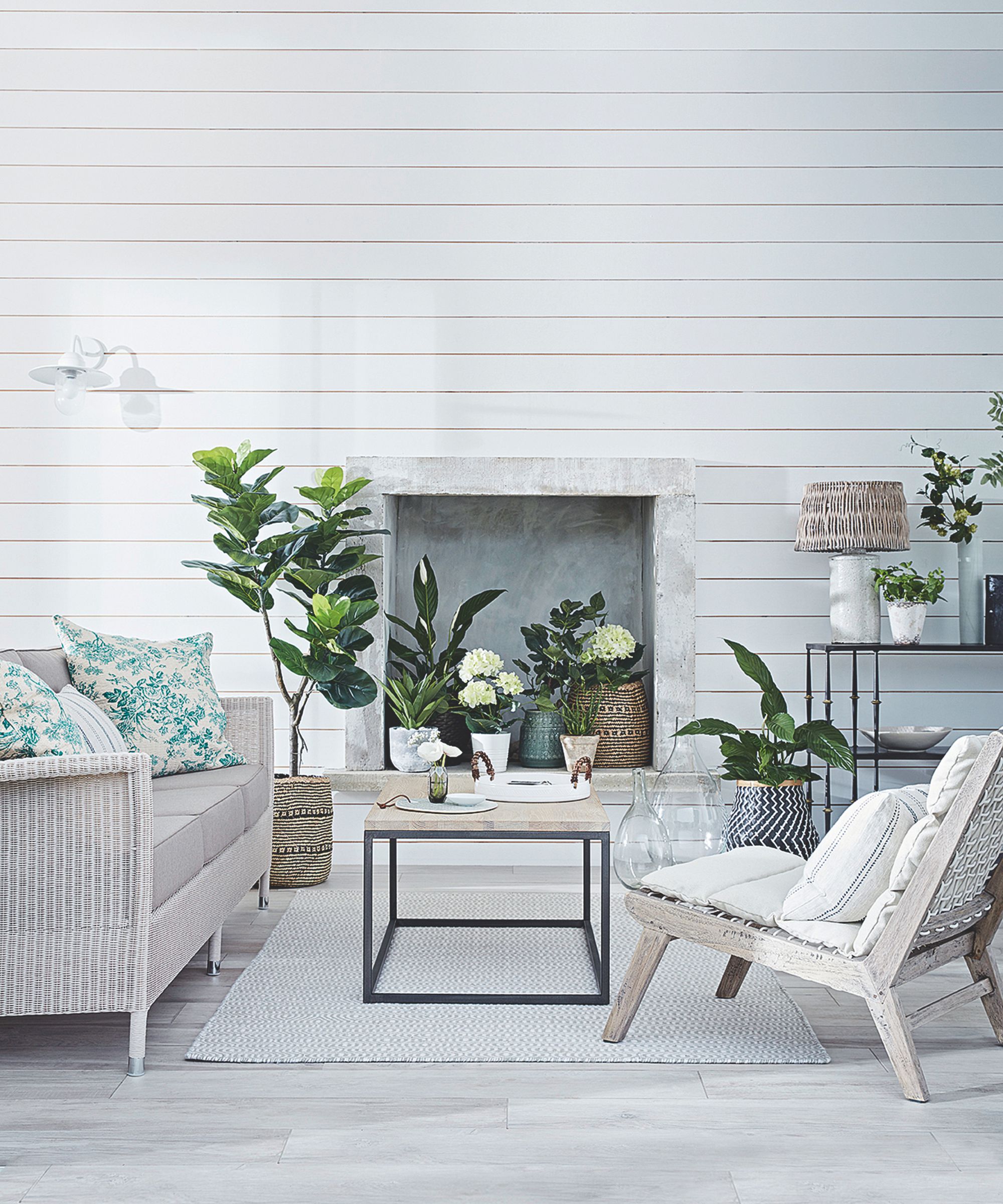 White panelled room with plants and neutral furniture