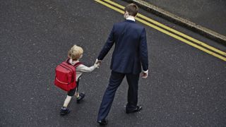 Men don't learn toxic masculinity from their fathers. Here, a father walking his young son to school.