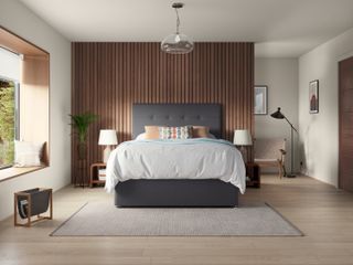 wood paneled bedroom wall with smoky gray button-back bed, and glass ceiling pendant.
