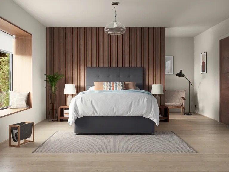 wood paneled bedroom wall with white bed