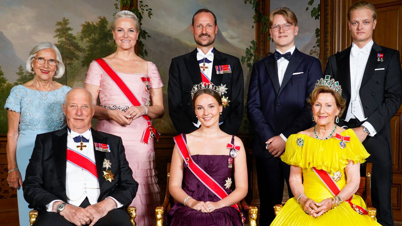 A formal portrait of the Norwegian royal family including the king, queen, crown prince and his family taken in 2022 posing in gowns, tiaras and tuxedos