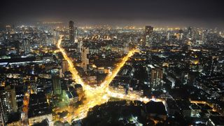 An aerial view of Mumbai at night, lit up by lights