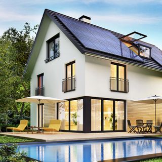 house exterior with solar panels and swimming pool