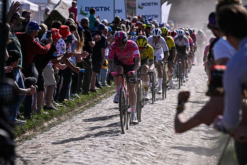 The pack of riders cycles on pavement during the fifth edition of the Paris-Roubaix women&#039;s race, 148,5 km between Denain and Roubaix, northern France on April 12, 2025. (Photo by JULIEN DE ROSA / AFP)