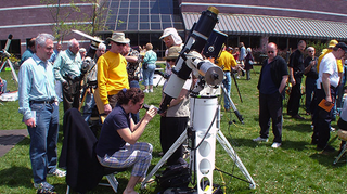 A Northeast Astronomy Forum attendee looks through a telescope.