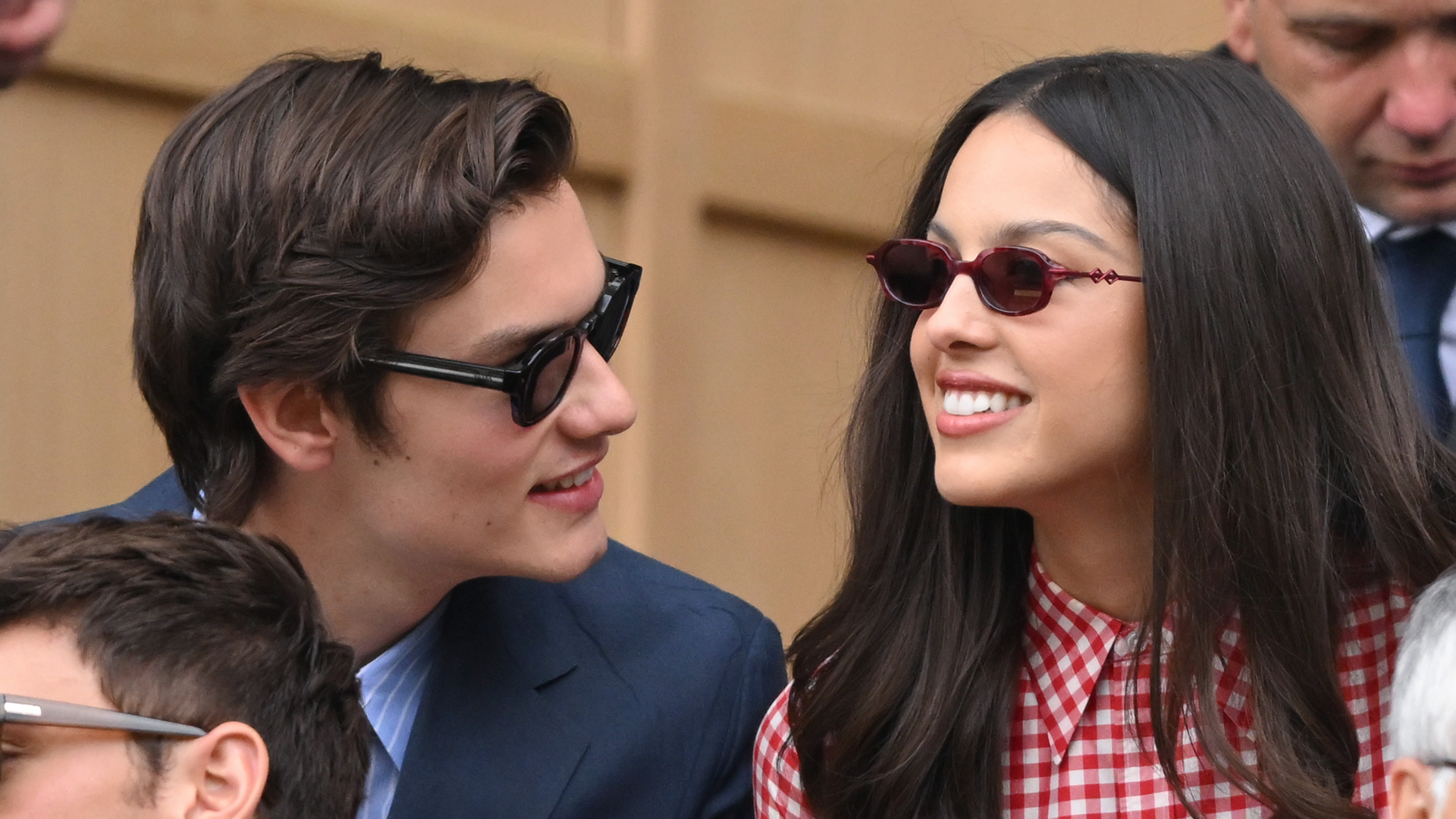 Olivia Rodrigo and boyfriend Louis Partridge attended Wimbledon2025 in a red gingham mini dress.