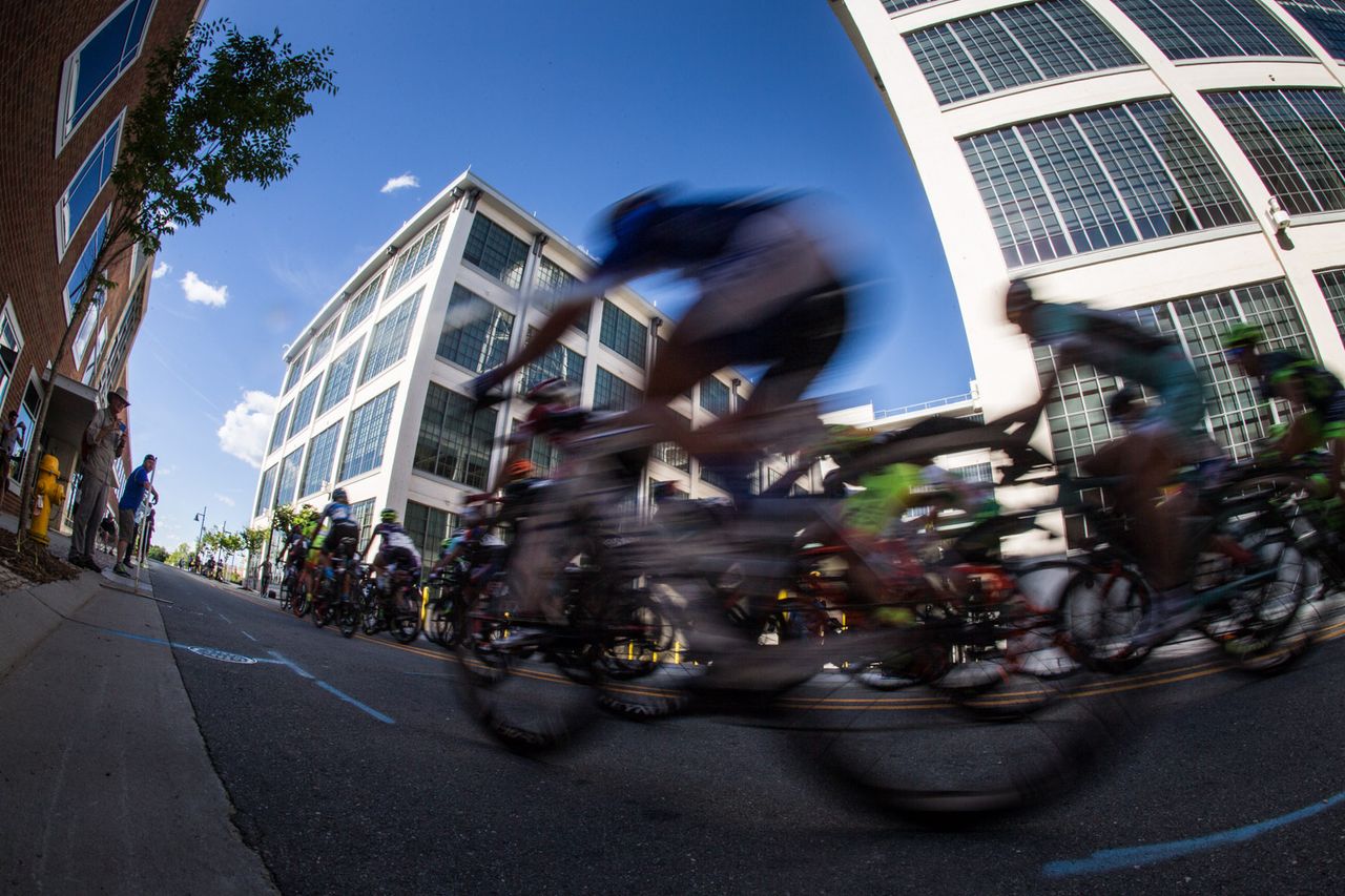 Riders pass by along the backside of the course.